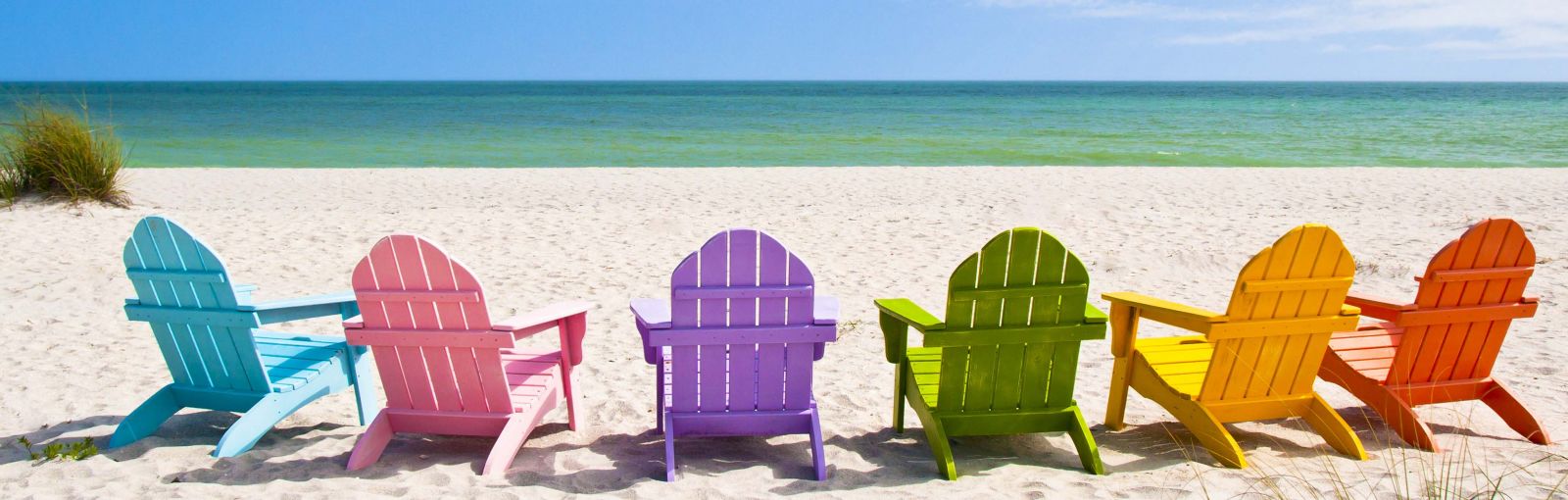 Different colored beach chairs on a beach