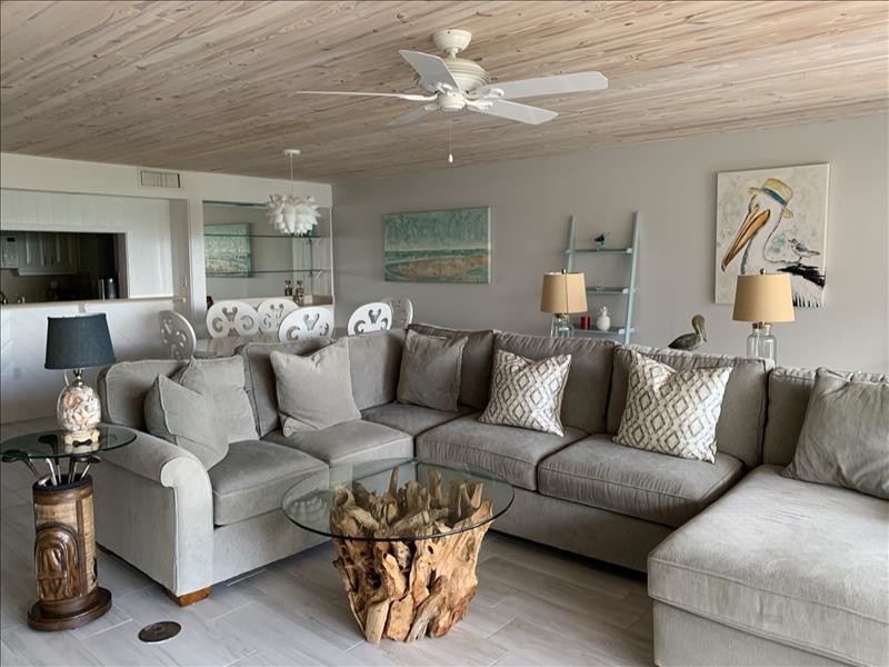 view of shorewood rental living room on sanibel island with light hues and tropical decor