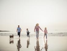 family with dog at beach
